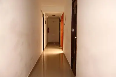 a long hallway with white walls and a long floor at Fenix Hotel Machupicchu in Machu Picchu