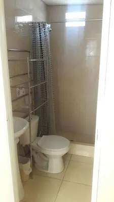 a bathroom with a toilet and a sink at Garden House Miraflores in Lima