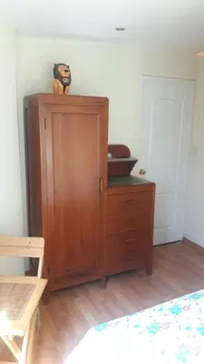 a bedroom with a wooden cabinet with a bowl on top at Garden House Miraflores in Lima