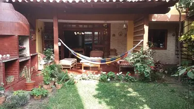 a porch with a hammock on a house at Garden House Miraflores in Lima
