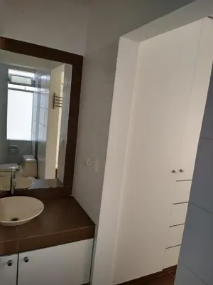 a bathroom with a sink and a mirror at Paracas Penthouse first line Boardwalk in Paracas