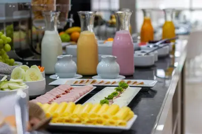 a buffet line with plates of food and drinks at Howard Johnson by Wyndham Lima Miraflores Art House in Lima