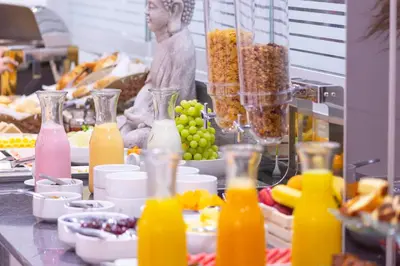 a buffet of food with bottles of orange juice at Howard Johnson by Wyndham Lima Miraflores Art House in Lima