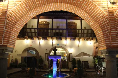 an archway in a building with a fountain in the middle at Hotel Marqueses in Cusco