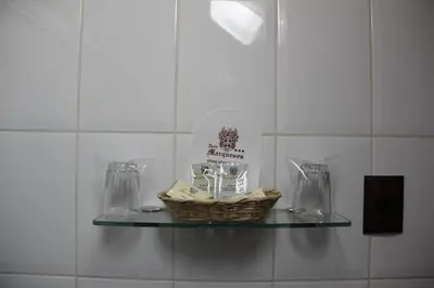a basket on a glass shelf in a bathroom at Hotel Marqueses in Cusco