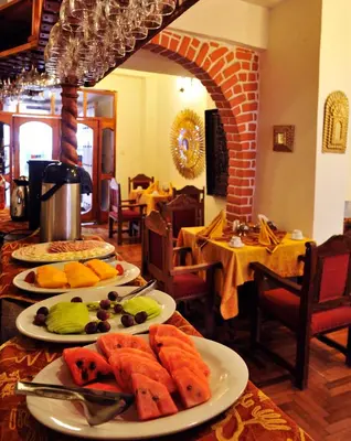 a table with three plates of food on it at Hotel Marqueses in Cusco