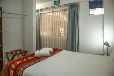 a bedroom with a bed with towels on it at Hotel Del Prado Hometown in Cusco