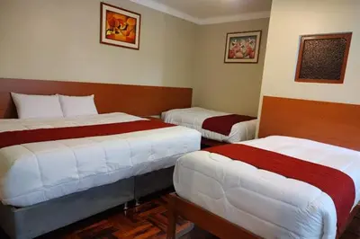 a hotel room with two beds in it at Marvelous Plaza in Cusco