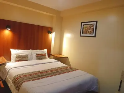 a bedroom with a large bed in a hotel room at Marvelous Plaza in Cusco