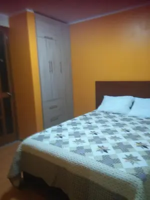 a bedroom with a bed and a closet and a door at PYMABET in Huancavelica