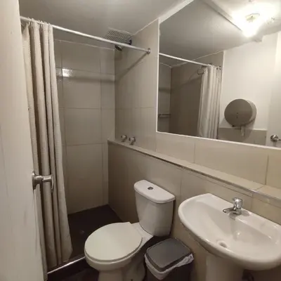 a bathroom with a toilet and a sink and a mirror at CASA SAPANTIANA, cerca a Sacsayhuaman in Cusco
