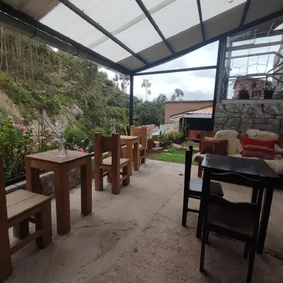 a group of tables and chairs under a tent at CASA SAPANTIANA, cerca a Sacsayhuaman in Cusco