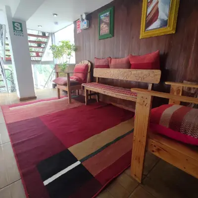 a bedroom with a bed and a rug at CASA SAPANTIANA, cerca a Sacsayhuaman in Cusco