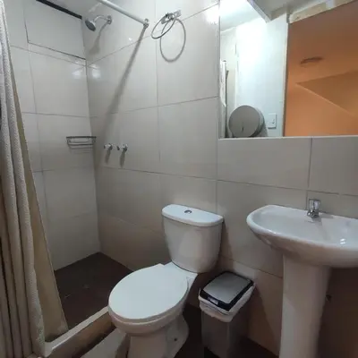 a bathroom with a toilet and a sink and a shower at CASA SAPANTIANA, cerca a Sacsayhuaman in Cusco
