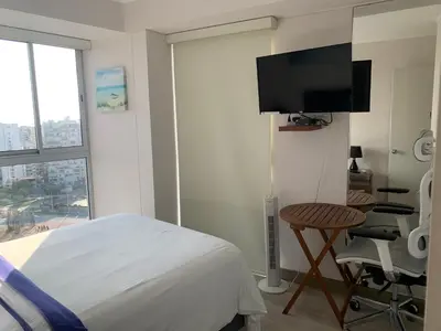 a bedroom with a bed and a flat screen tv at Connect in Lima