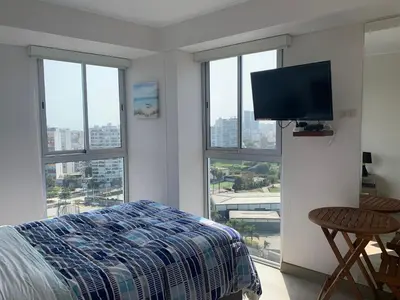 a bedroom with a bed and a flat screen tv at Connect in Lima