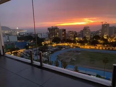 a view of a city at sunset from a balcony at Connect in Lima