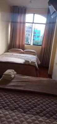 a bedroom with two beds and a window at Peruvian Wasi - Bed & Breakfast in Lima