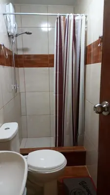 a bathroom with a toilet and a shower at Peruvian Wasi - Bed & Breakfast in Lima