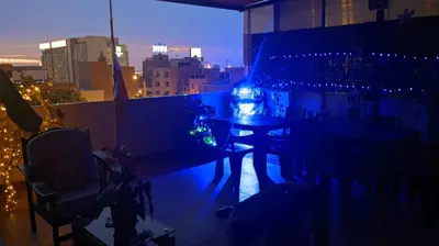 a room with a table and lights on a balcony at Peruvian Wasi - Bed & Breakfast in Lima