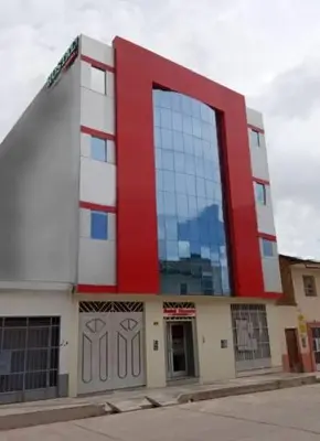a red and white building with a large window at Hotel ARKONA in Huancayo