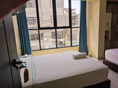 a bedroom with a bed and a large window at Hotel Konford Cañete in Imperial