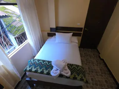 a bedroom with a bed with a stuffed animal on it at Don Feli House in Machu Picchu