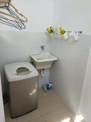 a white bathroom with a toilet and a sink at CASA BONITA in Lima