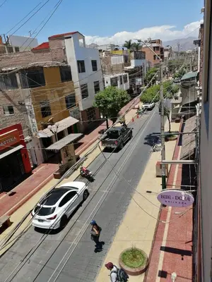 a white car parked on the side of a city street at Hostal Boulevard in Nazca