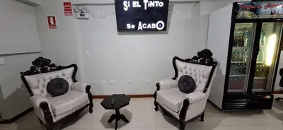 two chairs in a store with a sign on the wall at ANDINO HOTEL MACHUPICCHu in Machu Picchu