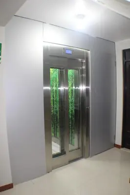 an elevator in a building with trees outside of it at ANDINO HOTEL MACHUPICCHu in Machu Picchu