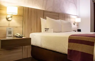 a hotel room with a bed and a telephone at Aku Hotels in Lima