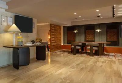 a lobby with a table and chairs and a dining room at Sonesta Hotel Miraflores in Lima