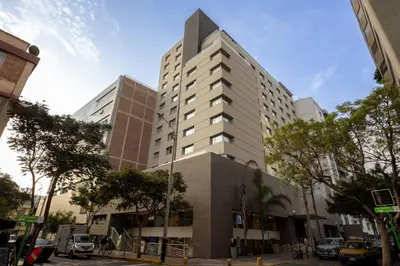 a tall white building on a city street at Sonesta Hotel Miraflores in Lima