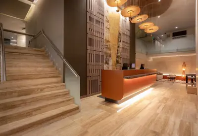 a staircase in a lobby with a stair case at Sonesta Hotel Miraflores in Lima