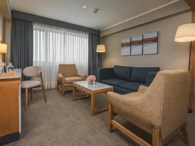a living room with a couch and a table at Sonesta Hotel Miraflores in Lima