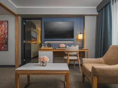 a living room with a desk and a tv at Sonesta Hotel Miraflores in Lima