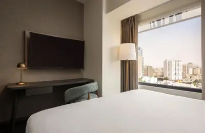 a hotel room with a bed and a desk and a window at Fairfield by Marriott Lima Miraflores in Lima