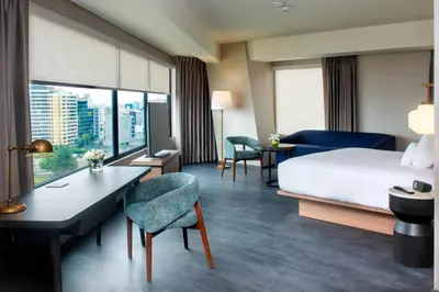 a hotel room with a bed and a desk and chairs at Fairfield by Marriott Lima Miraflores in Lima