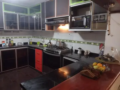 a kitchen with a sink and a stove top oven at Inka Ayllu Hospedaje in Lima
