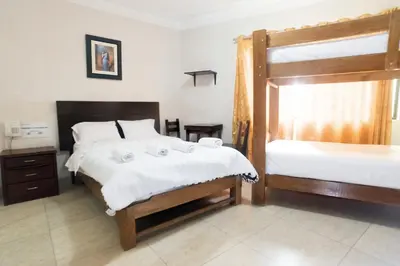 a bedroom with two beds and a bunk bed at Hostal Sueños Breña in Lima