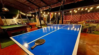 a ping pong table with a paddle on top of it at Valle verde, Hostel & camping in Urubamba