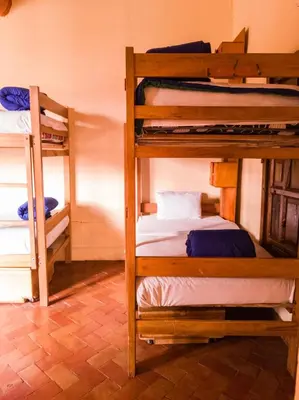 a room with three bunk beds in a room at Loki Cusco in Cusco