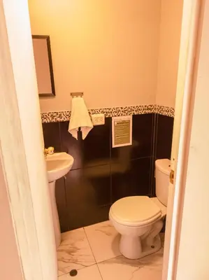a bathroom with a toilet and a sink at Loki Cusco in Cusco
