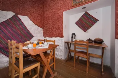 a dining room with a wooden table and chairs at LO NUESTRO House in Cusco