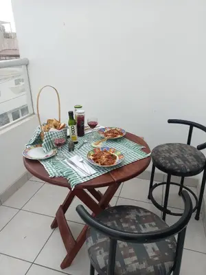 a table with plates of food and drinks on it at El Refugio in Punta Hermosa