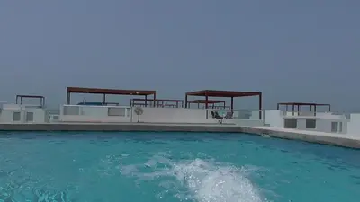 a swimming pool with blue water in front of a building at Donde Lalo in Asia