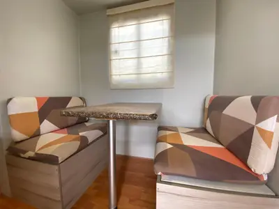 a room with two chairs and a table and a window at Casa Caravanas in Paracas