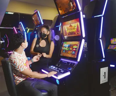 a man and a woman playing a video game at Real Hotel in Huánuco