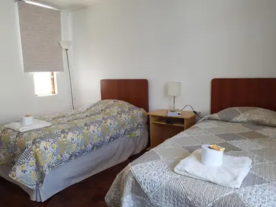 two beds sitting next to each other in a room at EL ENSUEÑO in Lima